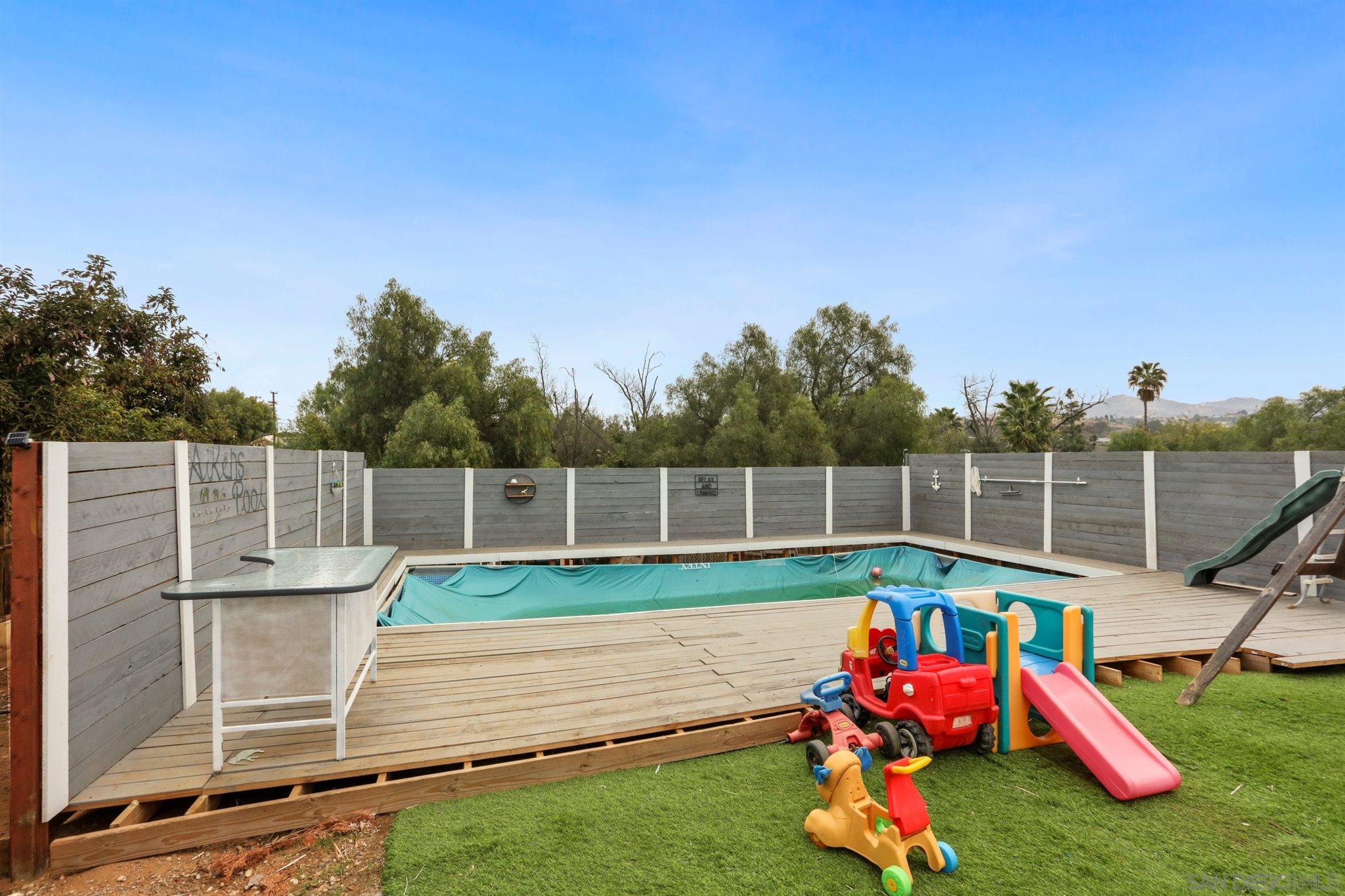 8521 Gaena Road Lakeside, CA 92040 - Photo 23 of 27 a view of a small yard and a wooden deck