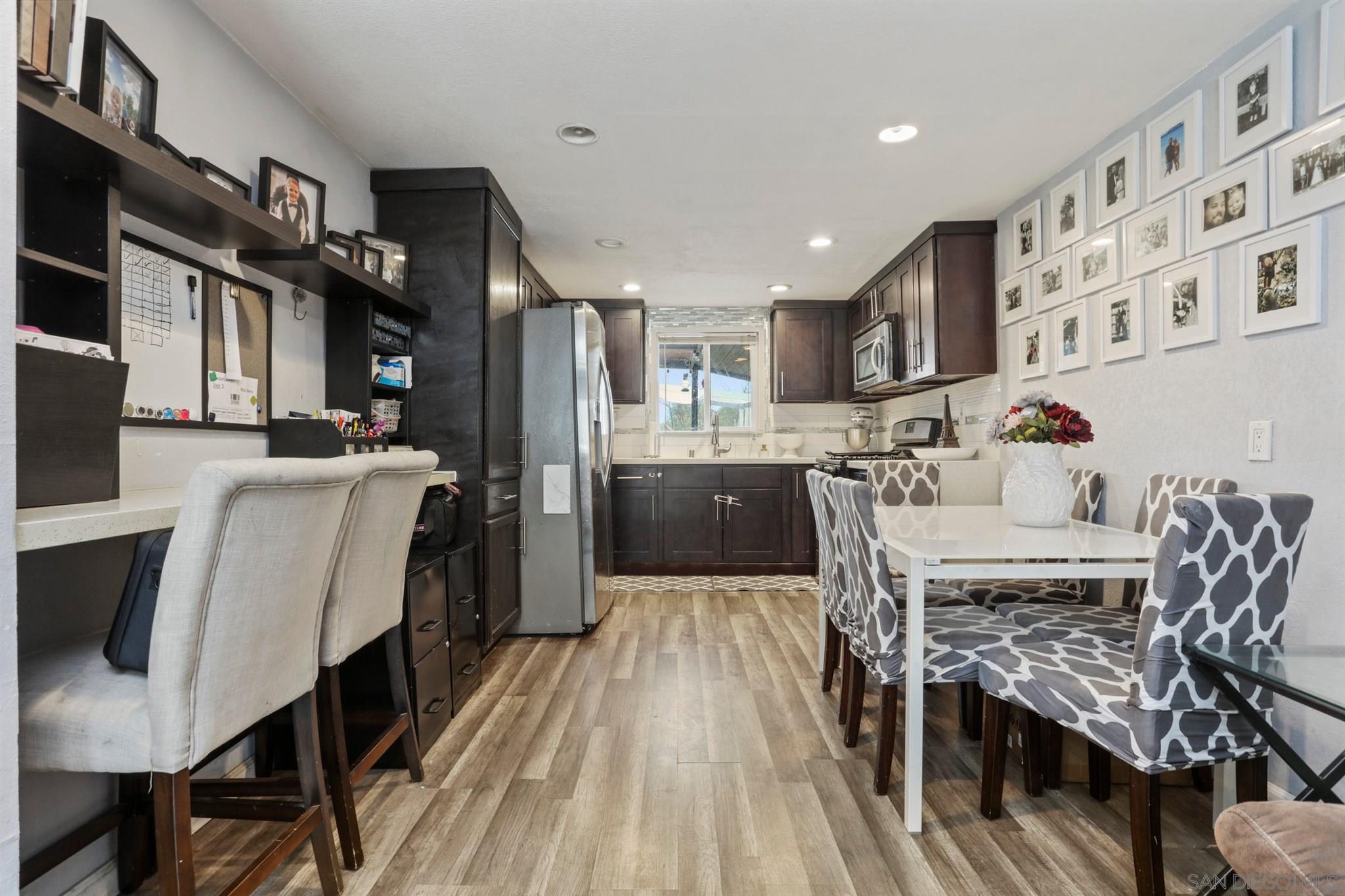8521 Gaena Road Lakeside, CA 92040 - Photo 6 of 27 a kitchen with stainless steel appliances a dining table chairs stove and cabinets