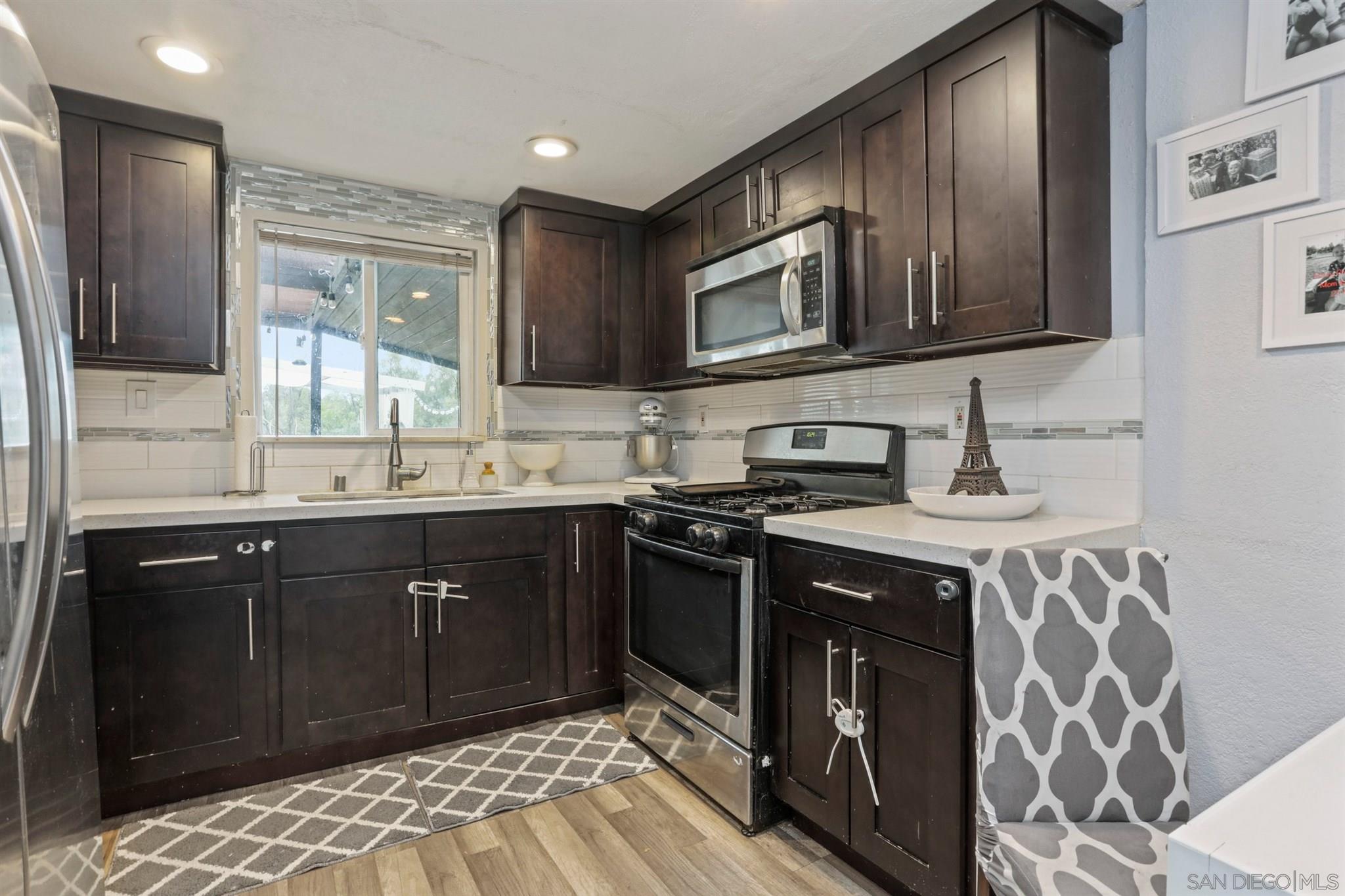 8521 Gaena Road Lakeside, CA 92040 - Photo 8 of 27 a kitchen with stainless steel appliances granite countertop a sink stove and refrigerator