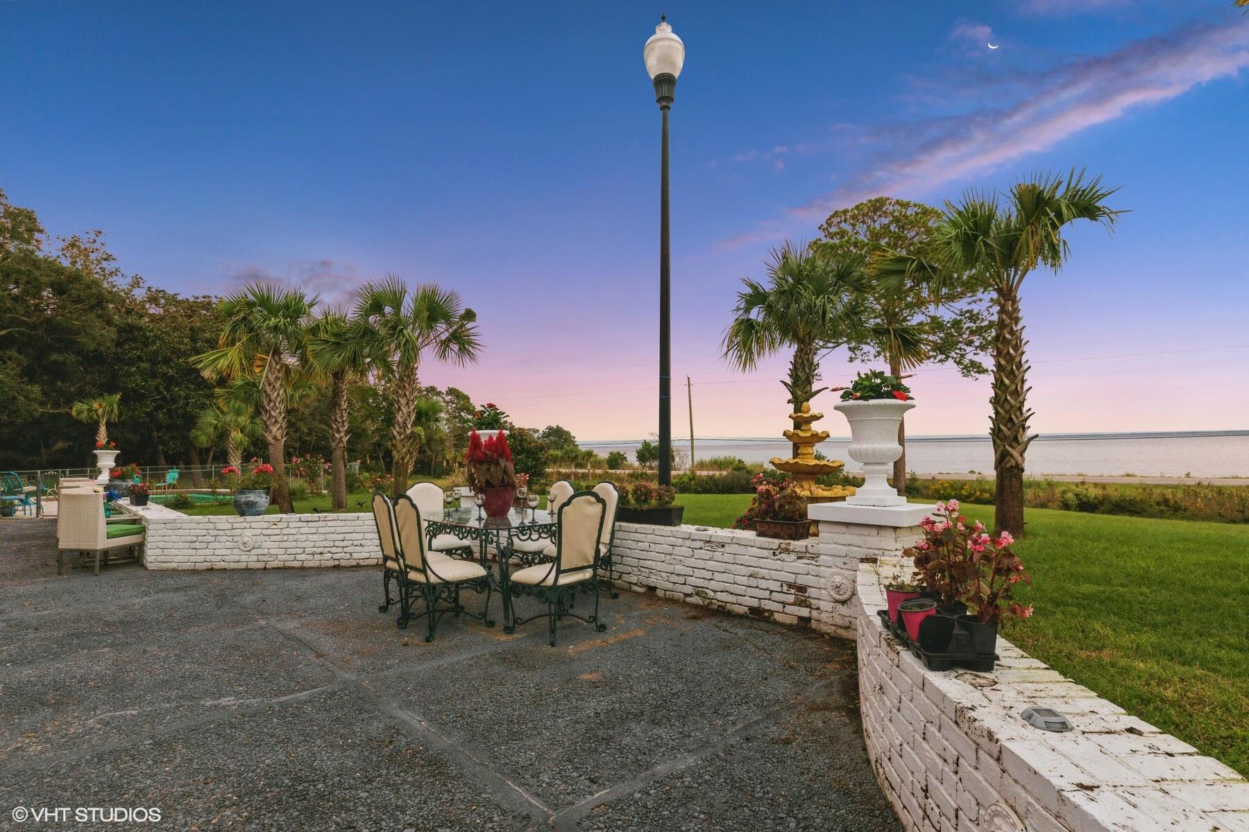 13000 Highway 20 Freeport, FL 32439 - Photo 26 of 31 a view of a patio with couches and table and chairs with wooden fence