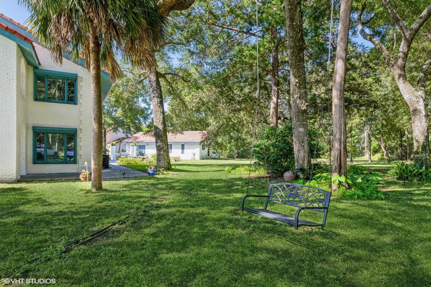 13000 Highway 20 Freeport, FL 32439 - Photo 3 of 31 a garden with a bench in a garden