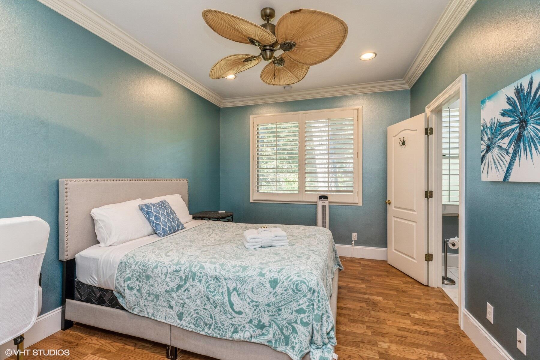 13000 Highway 20 Freeport, FL 32439 - Photo 10 of 31 a bedroom with a large bed and a chandelier