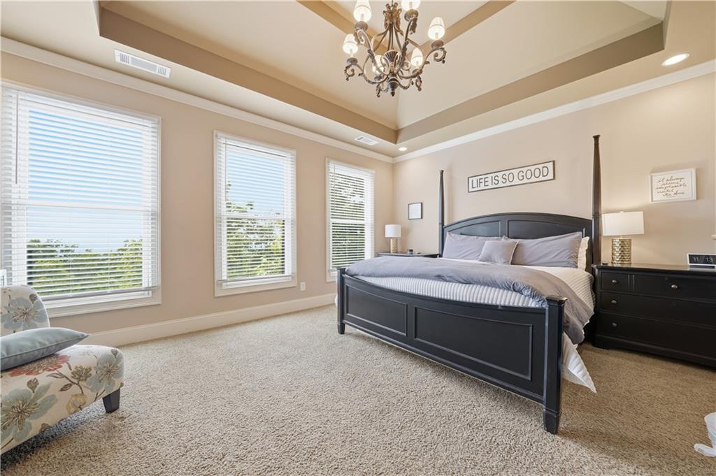97 Eagle Ridge Trail Cleveland, GA 30528 - Photo 32 of 58 a bedroom with a large bed and a chandelier