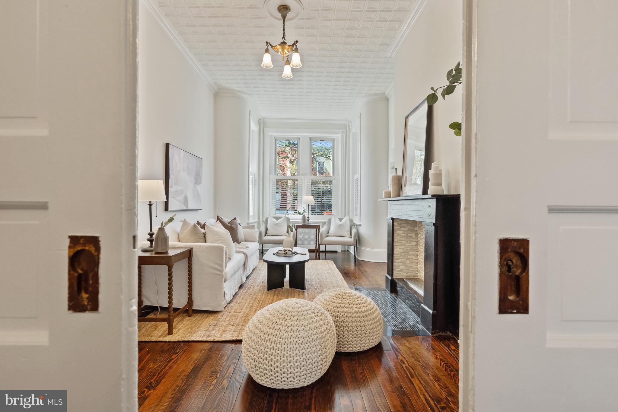 705 7th Street Northeast Washington, DC 20002 - Photo 12 of 48 a living room with fireplace furniture and a chandelier
