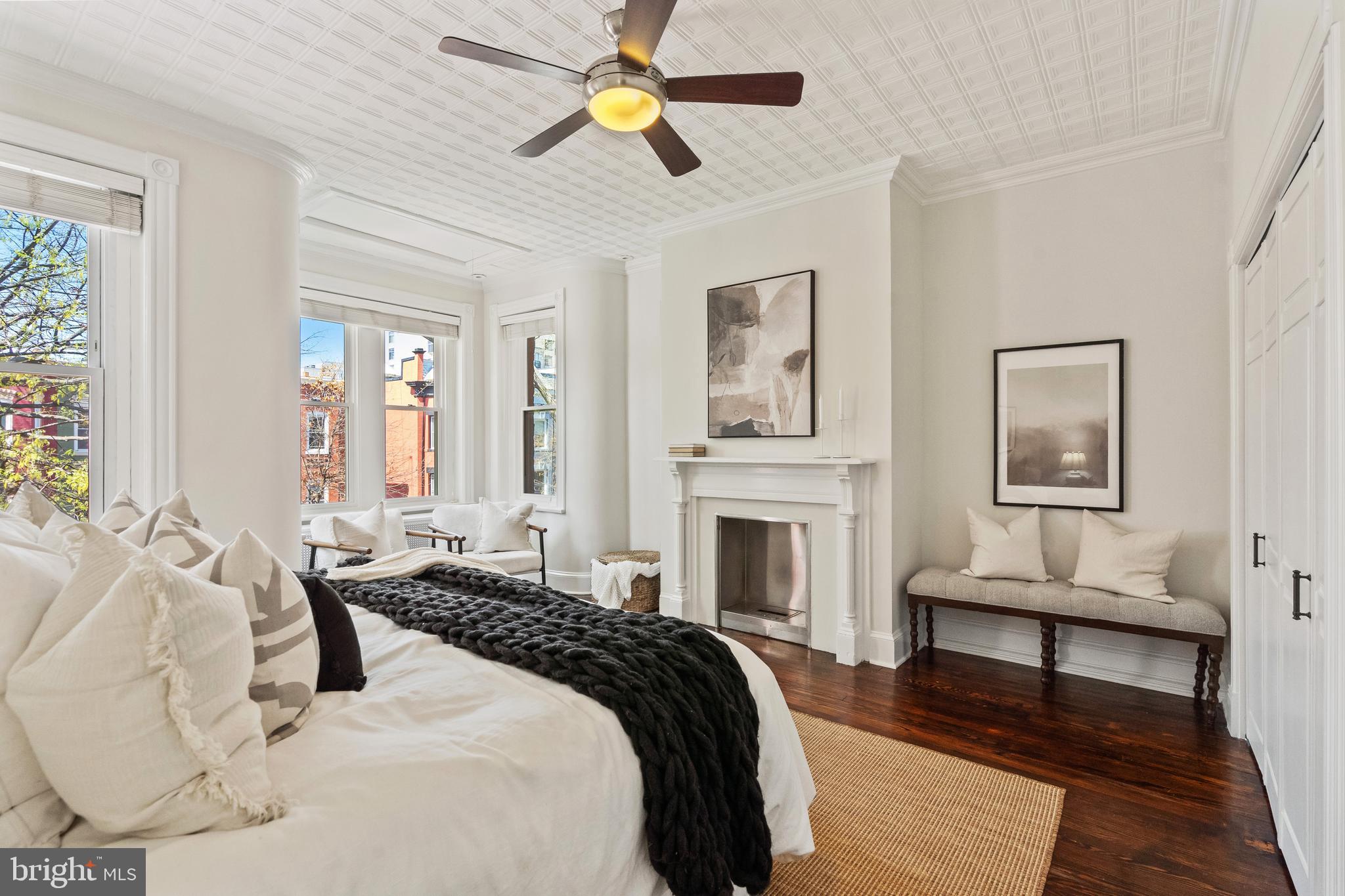 705 7th Street Northeast Washington, DC 20002 - Photo 20 of 48 a spacious bedroom with a bed and a chandelier