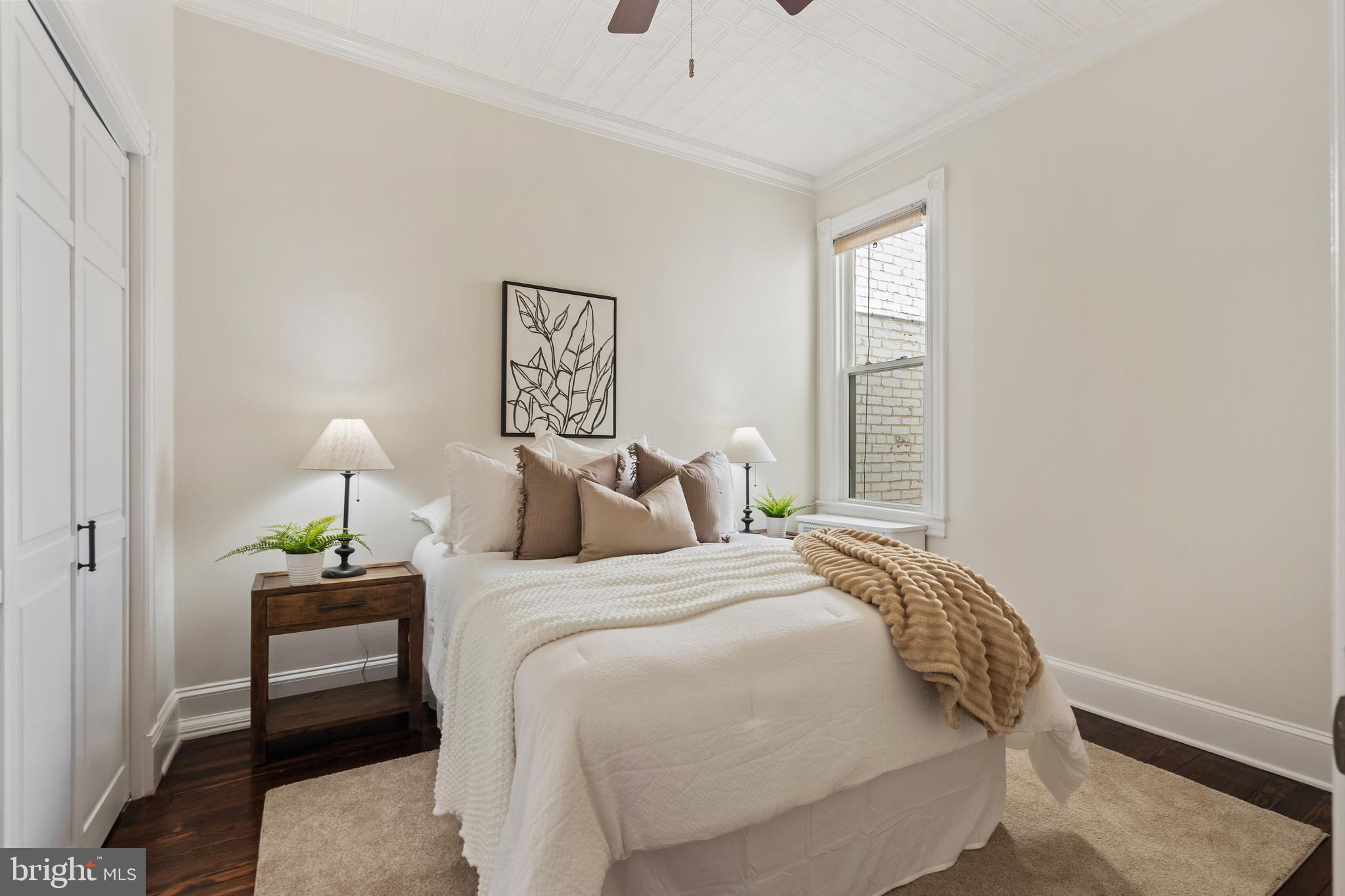 705 7th Street Northeast Washington, DC 20002 - Photo 27 of 48 a bedroom with a bed and a window