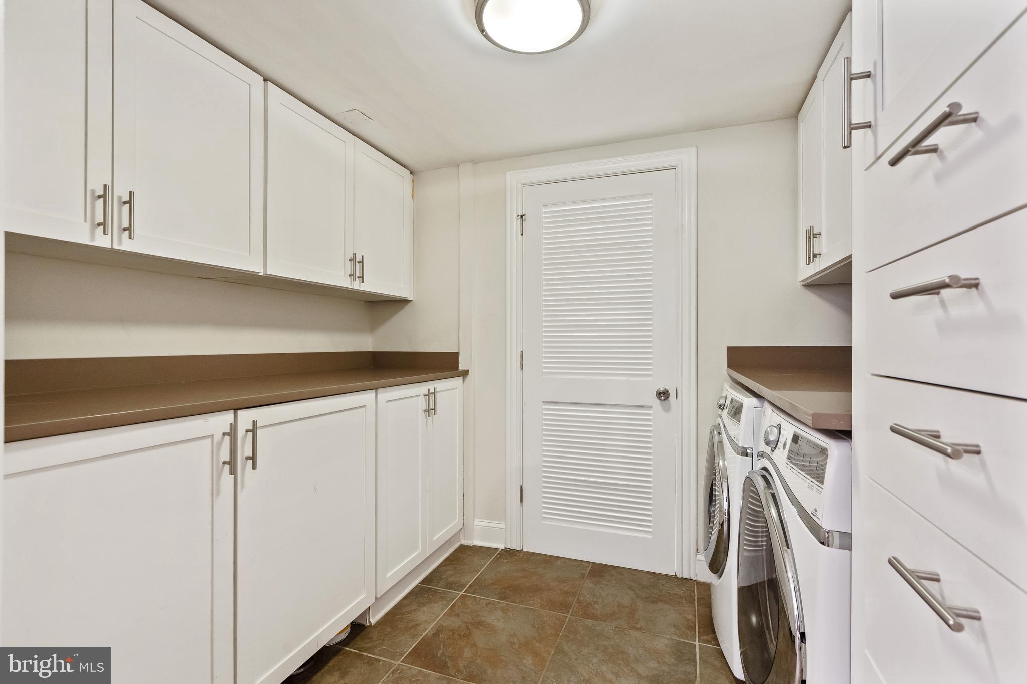 705 7th Street Northeast Washington, DC 20002 - Photo 40 of 48 a utility room with cabinets washer and dryer