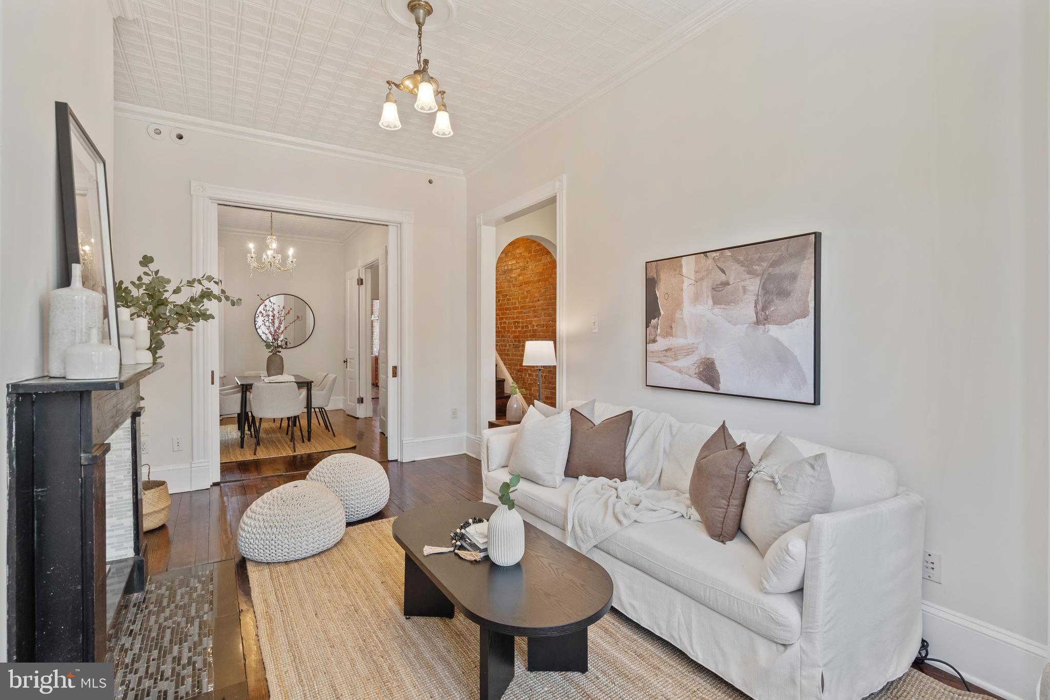 705 7th Street Northeast Washington, DC 20002 - Photo 9 of 48 a living room with furniture and a chandelier