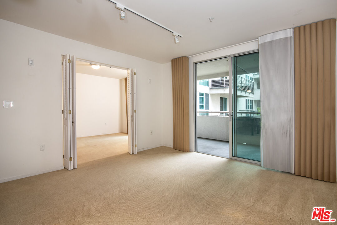 an empty room with sliding glass door