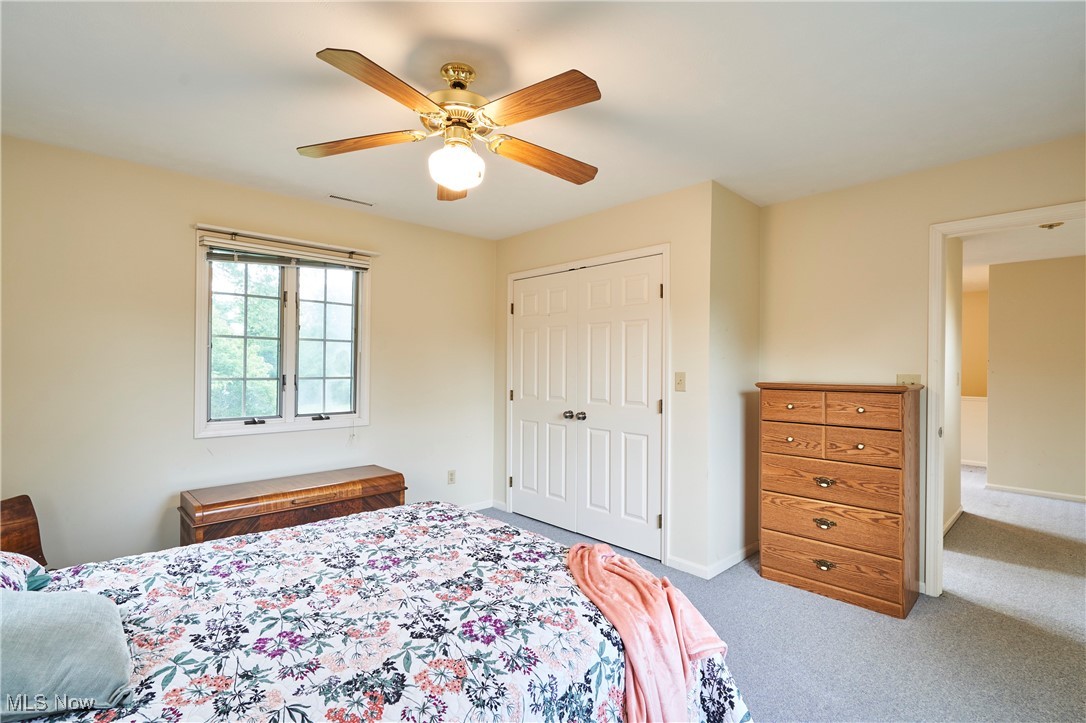 2610 Shade Road Akron, OH 44333 - Photo 25 of 45 Bedroom 4 featuring light colored carpet, ceiling fan, and a double closet