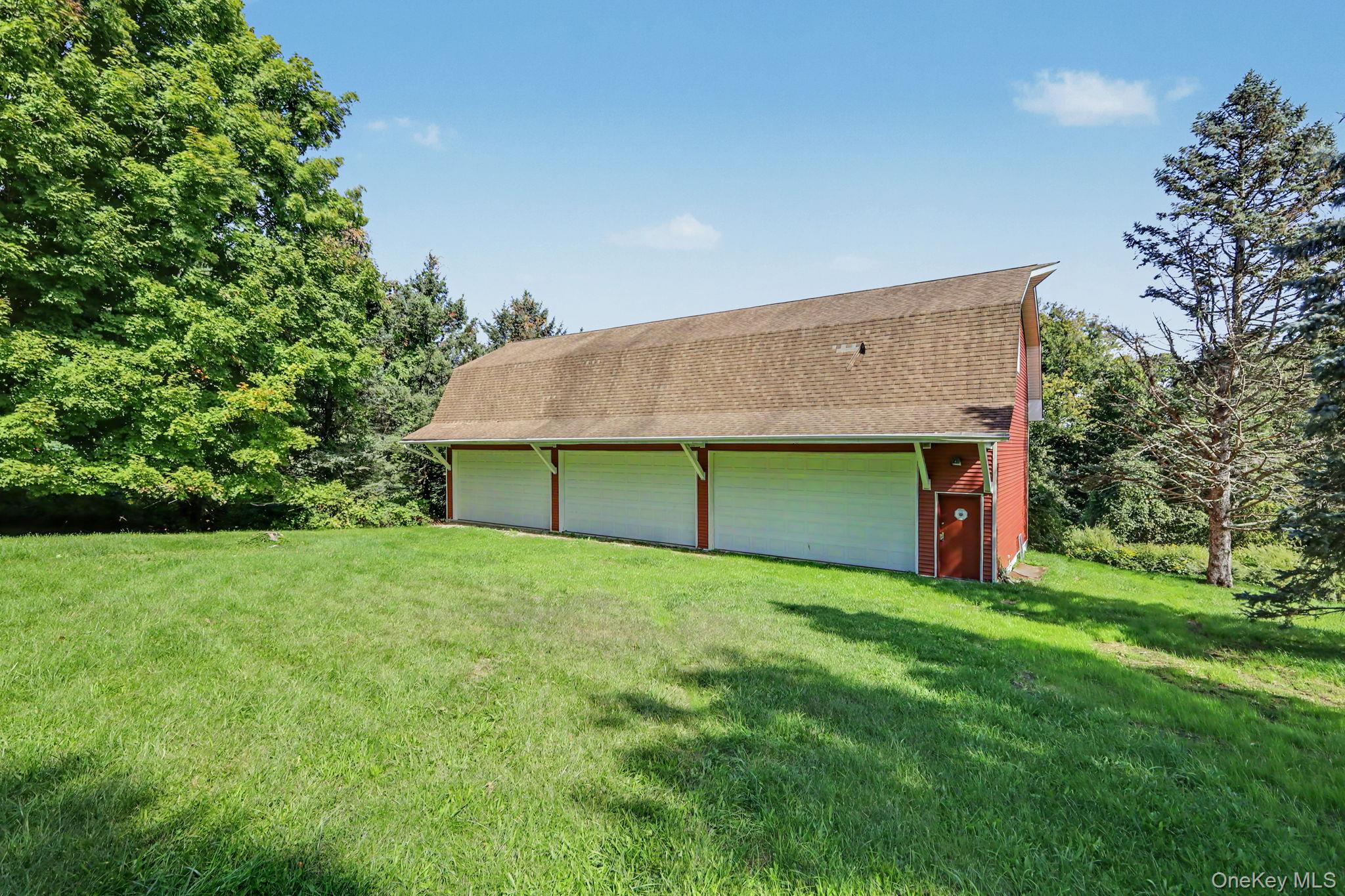 214 Starr Ridge Road Brewster, NY 10509 - Photo 36 of 37 detached three-car garage and barn (70' x 27') and each garage bay is 10' high x 20' wide. Garage and barn has a full pine staircase which leads to the large unfinished second story. Ideal for the car enthusiast, hobbyist, contractor, collector, or anyone looking for exceptional workspace, the barn is equipped with electrical, professional car lifts and offers plenty of room for multiple vehicles, equipment, tools, and storage.