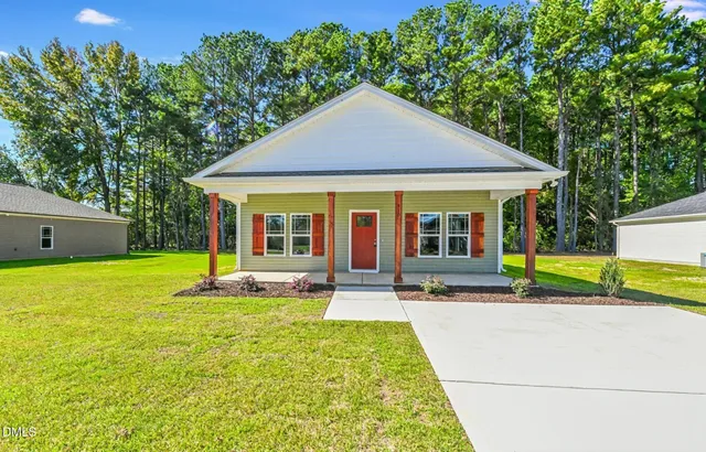 a house view with swimming pool and glass windows