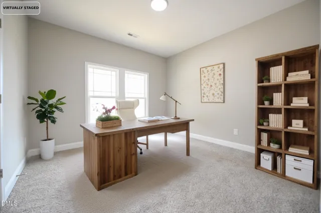 a view of a workspace with furniture and a potted plant