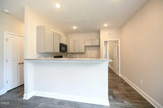 a kitchen with stainless steel appliances a refrigerator sink and microwave