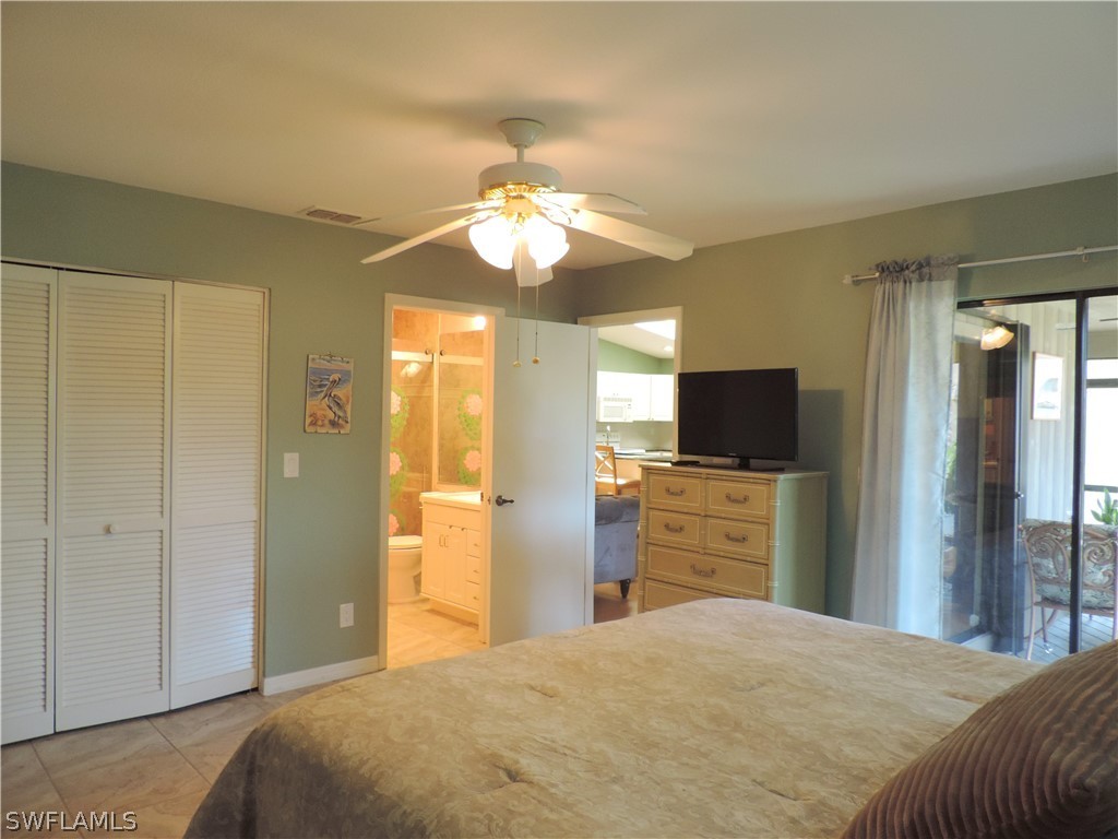 17624 Village Inlet Court Fort Myers, FL 33908 - Photo 11 of 17 a bedroom with a bed and a flat tv screen on dresser