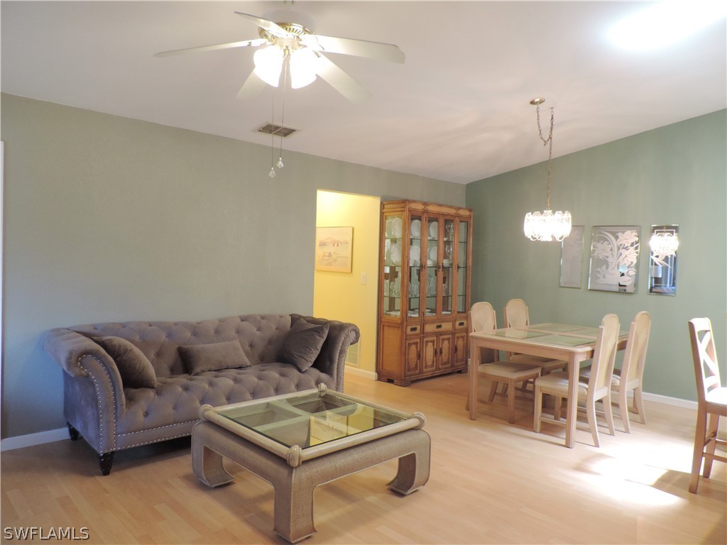 17624 Village Inlet Court Fort Myers, FL 33908 - Photo 5 of 17 a living room with furniture and a chandelier