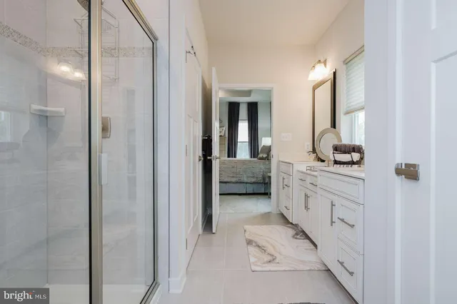 a bathroom with a double vanity sink and a mirror
