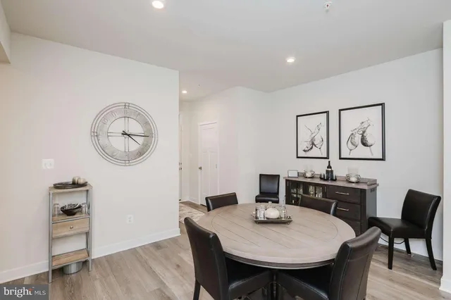 a view of a dining room with furniture a chandelier and wooden floor