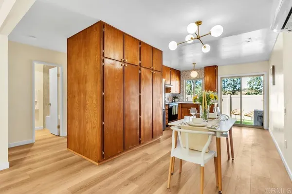 a view of a dining room with furniture wooden floor and chandelier