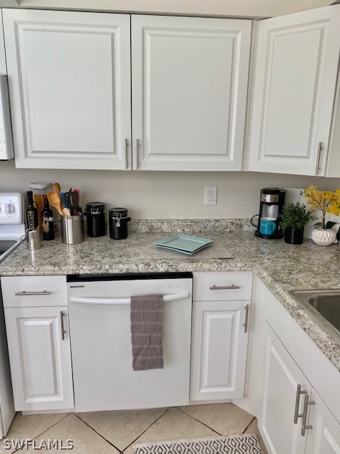 306 Oregon Road West Lehigh Acres, FL 33936 - Photo 11 of 26 a kitchen with white cabinets and white appliances