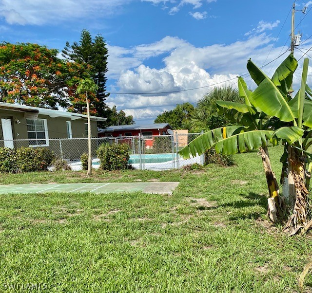306 Oregon Road West Lehigh Acres, FL 33936 - Photo 18 of 26 a backyard of a house with lots of green space