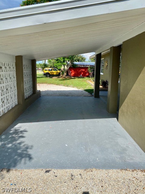 306 Oregon Road West Lehigh Acres, FL 33936 - Photo 20 of 26 a living room with furniture and a floor to ceiling window