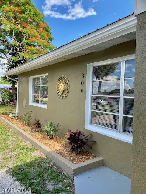 306 Oregon Road West Lehigh Acres, FL 33936 - Photo 2 of 26 a front view of a house with a yard