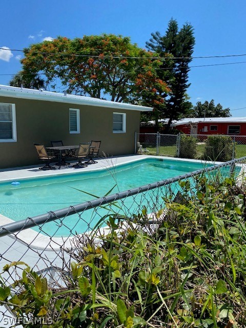 306 Oregon Road West Lehigh Acres, FL 33936 - Photo 23 of 26 a view of a backyard with plants and a garden