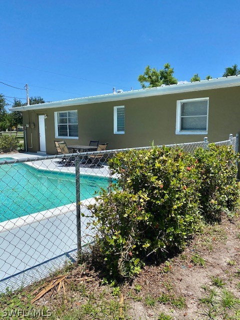 306 Oregon Road West Lehigh Acres, FL 33936 - Photo 24 of 26 a view of a house with backyard and garden