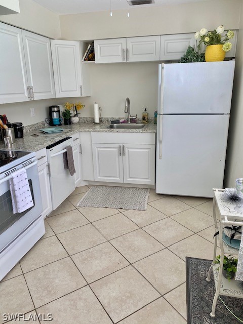 306 Oregon Road West Lehigh Acres, FL 33936 - Photo 5 of 26 a kitchen with a sink a stove a refrigerator and cabinets