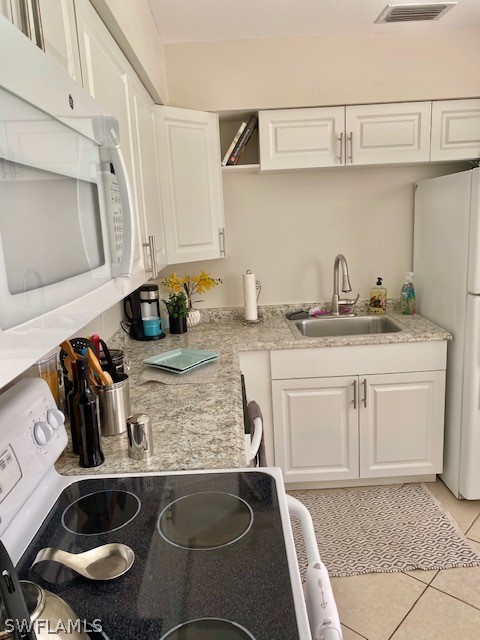 306 Oregon Road West Lehigh Acres, FL 33936 - Photo 6 of 26 a kitchen with a sink and cabinets