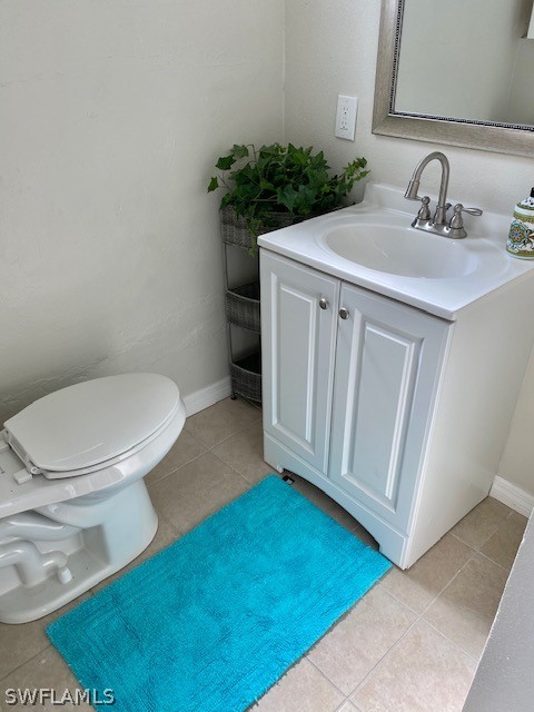 306 Oregon Road West Lehigh Acres, FL 33936 - Photo 8 of 26 a bathroom with a sink toilet and mirror