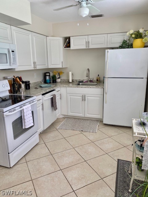 306 Oregon Road West Lehigh Acres, FL 33936 - Photo 10 of 26 a kitchen with a stove top oven sink and cabinets