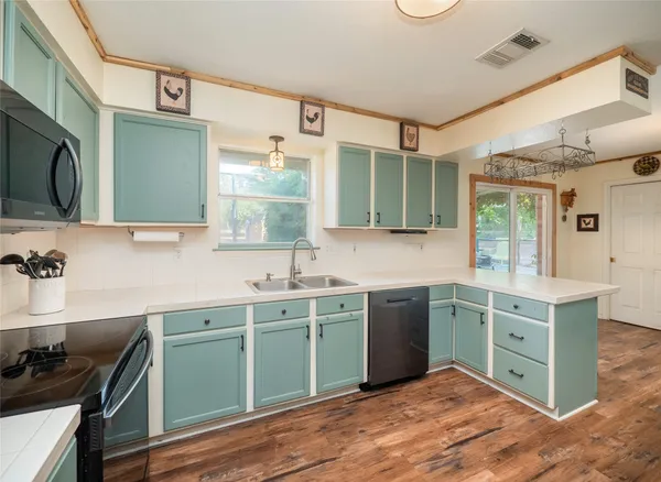 a kitchen with stainless steel appliances a refrigerator and cabinets