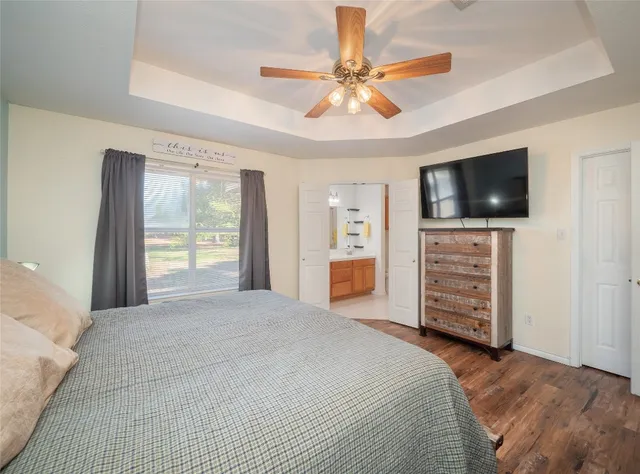 a bedroom with a bed and a flat screen tv