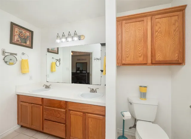 a bathroom with a toilet a sink and mirror