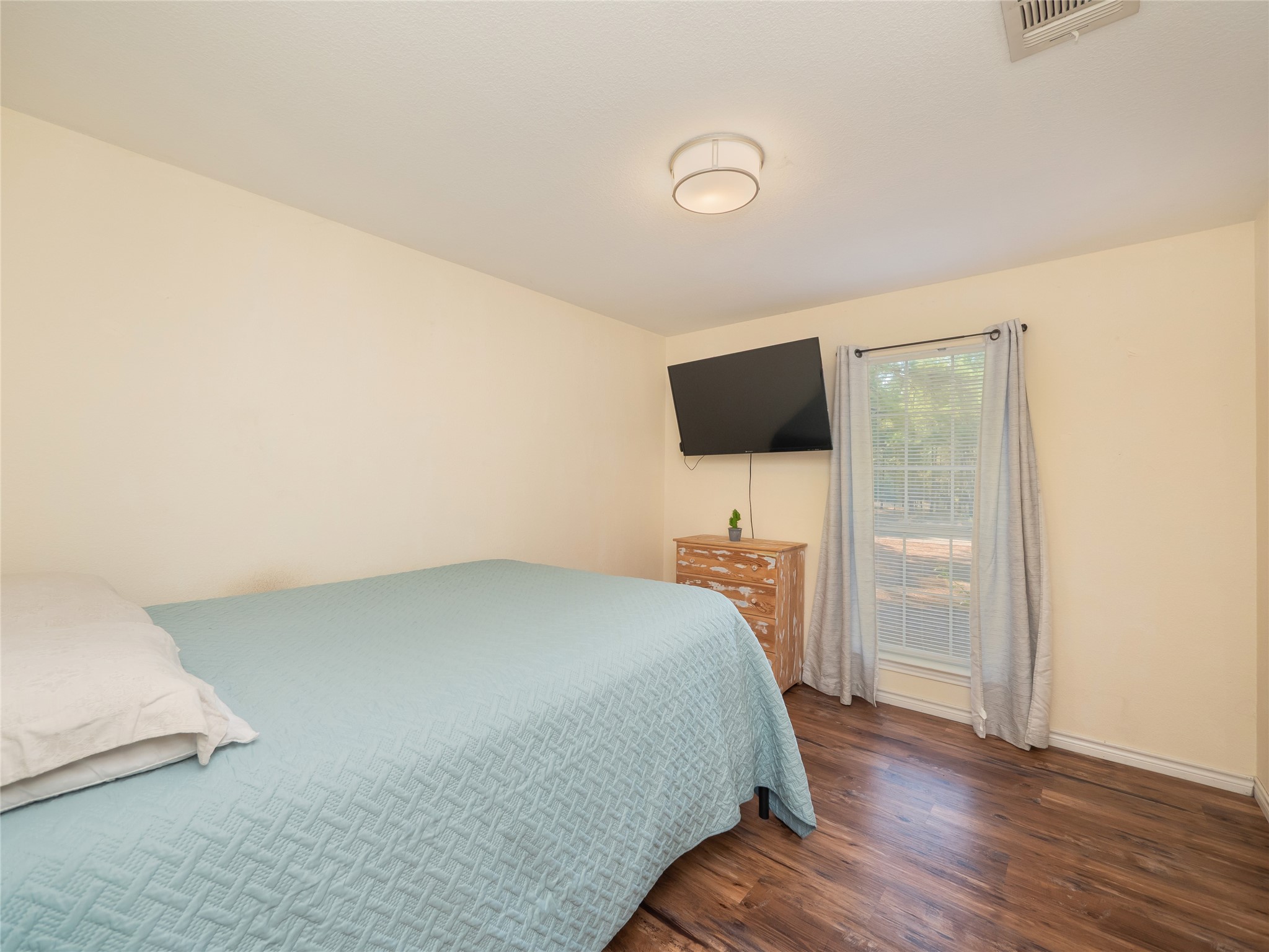 228 Old Firetower Road Bastrop, TX 78602 - Photo 19 of 40 a bedroom with a bed and a flat screen tv