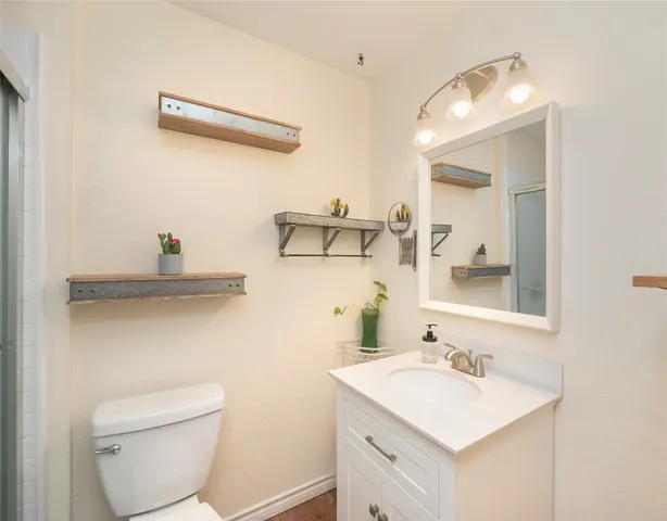 a bathroom with a toilet sink and mirror