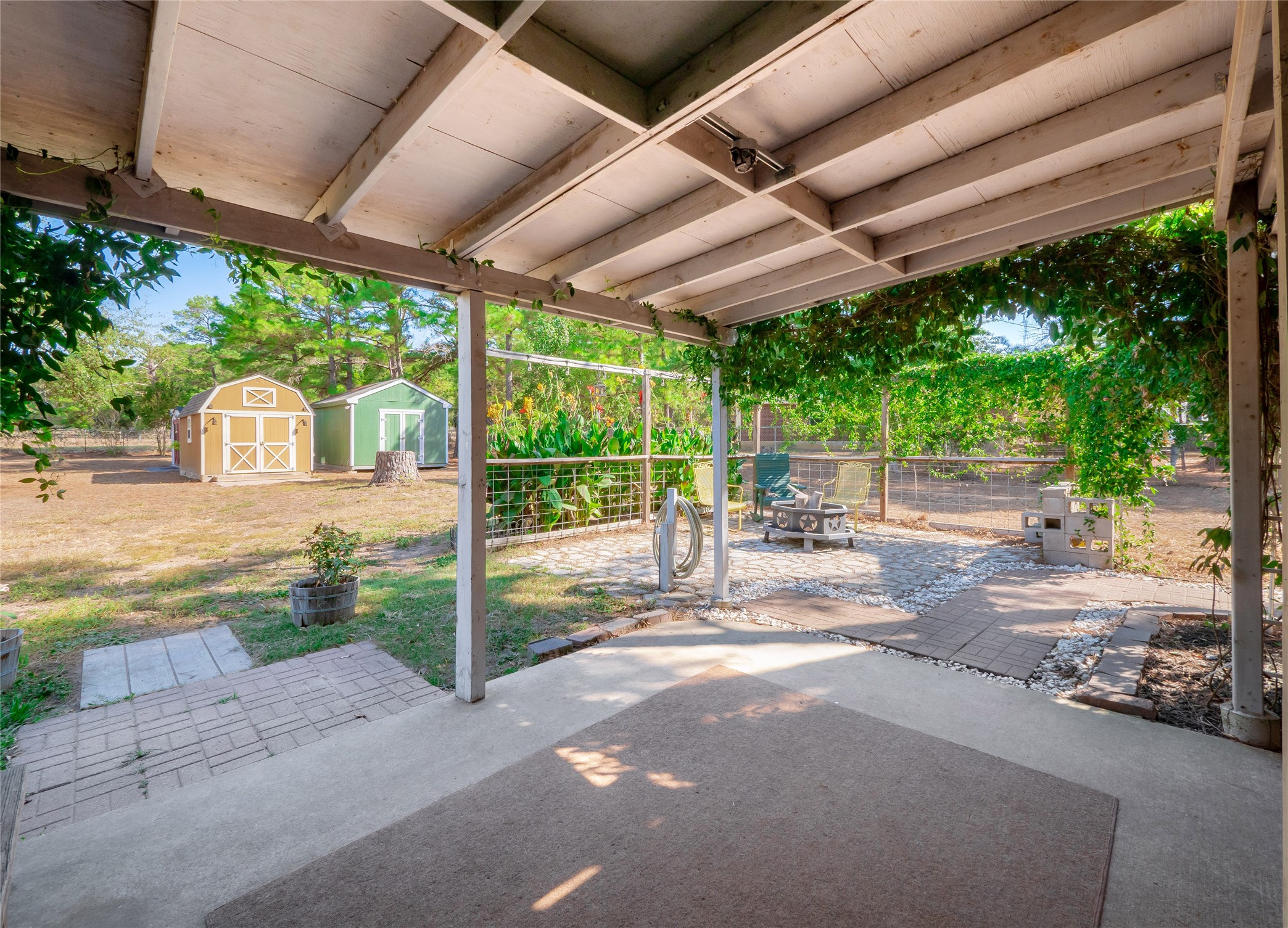 228 Old Firetower Road Bastrop, TX 78602 - Photo 26 of 40 a view of a backyard with floor to ceiling window and wooden fence