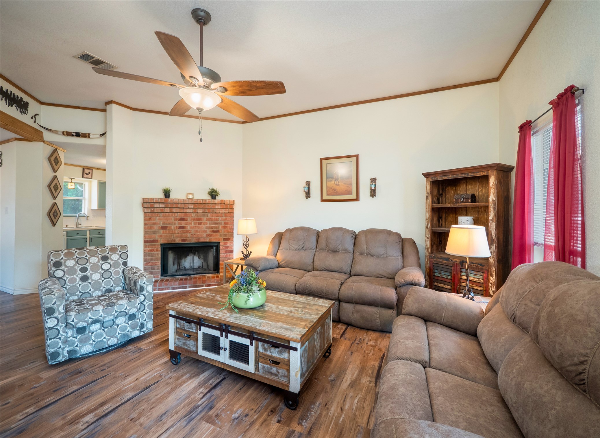 228 Old Firetower Road Bastrop, TX 78602 - Photo 5 of 40 a living room with furniture a fireplace and a ceiling fan