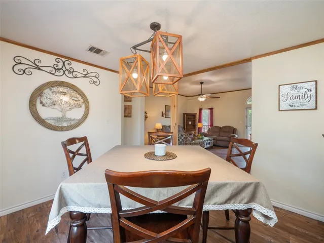 a view of a dining room with furniture and a chandelier
