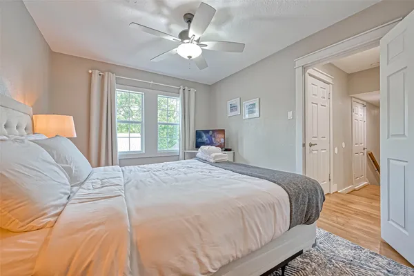 a bedroom with a large bed and a chandelier