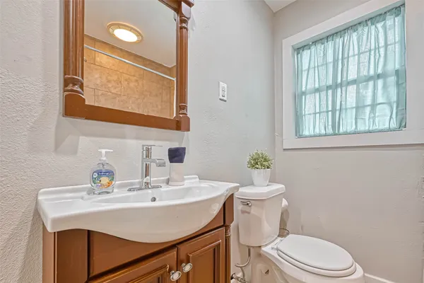 a bathroom with a sink a mirror and a toilet