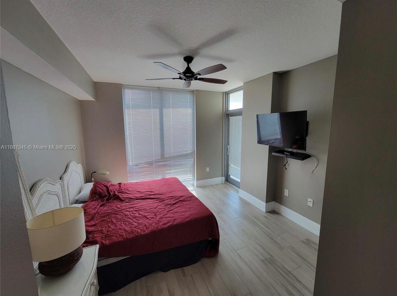 140 South Dixie Highway, Unit 519 Hollywood, FL 33020 - Photo 16 of 28 a bedroom with a bed and a flat screen tv