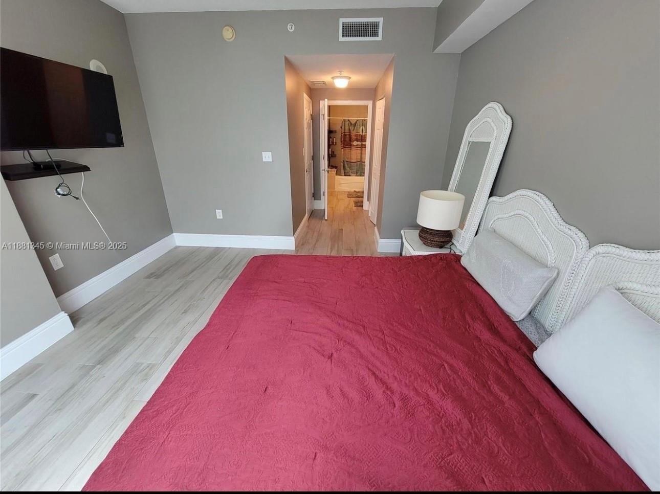 140 South Dixie Highway, Unit 519 Hollywood, FL 33020 - Photo 17 of 28 a bedroom with a bed and a flat screen tv