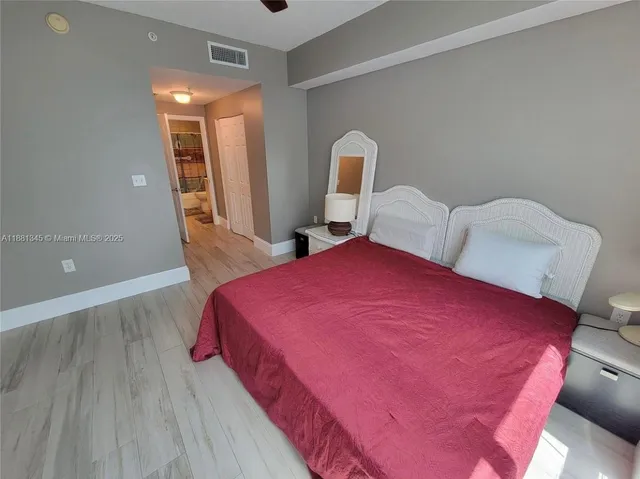 a bedroom with a bed and a mirror