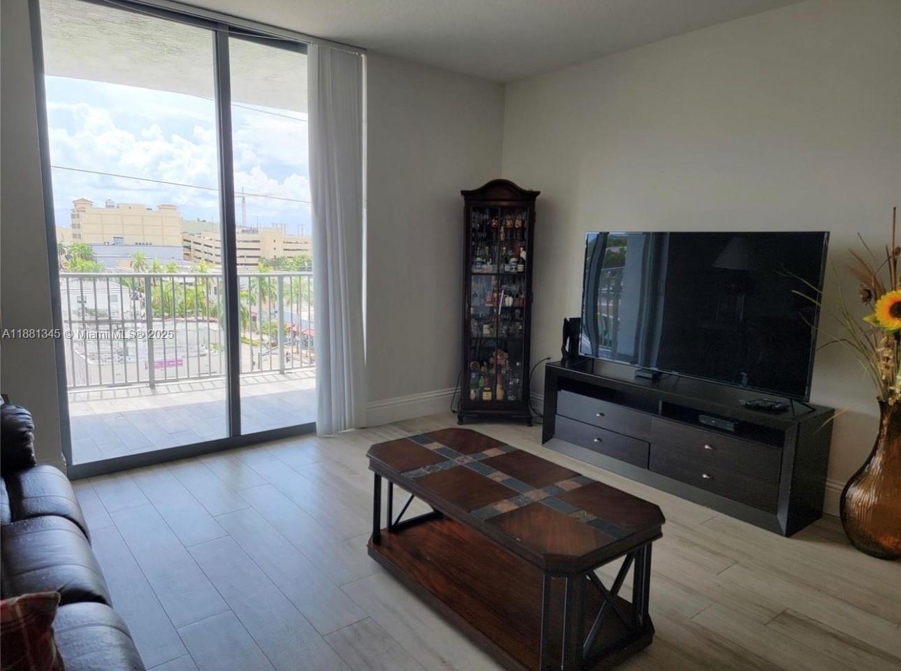 140 South Dixie Highway, Unit 519 Hollywood, FL 33020 - Photo 2 of 28 a living room with furniture and a flat screen tv