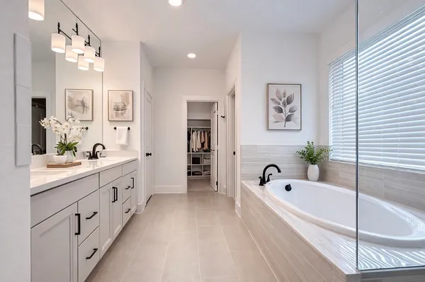 a bathroom with a tub a sink and mirror