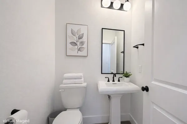 a bathroom with a toilet sink and mirror