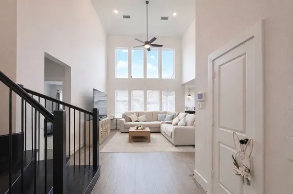 a living room with furniture a chandelier and a chandelier